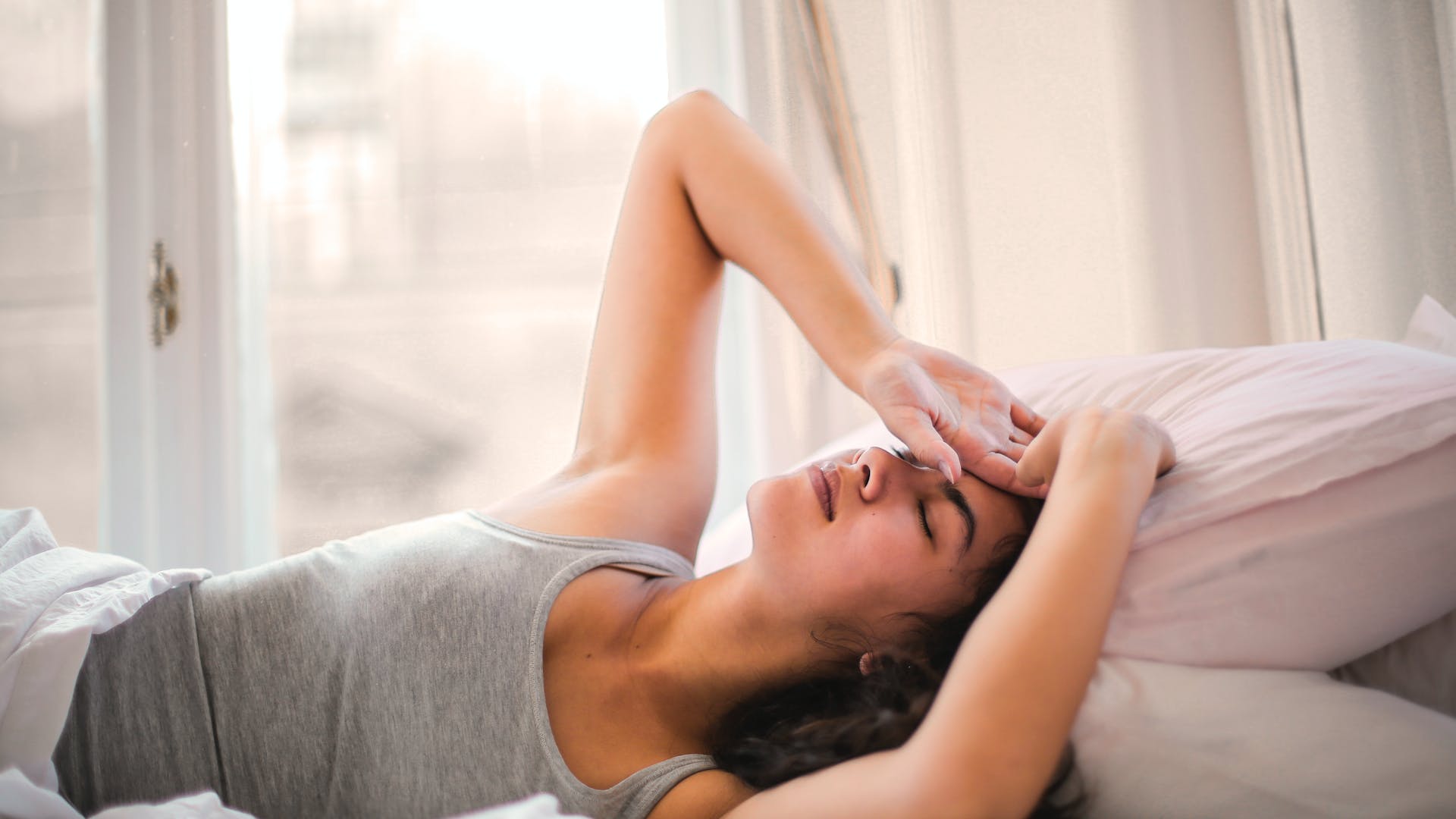 lady feeling nauseous in bed