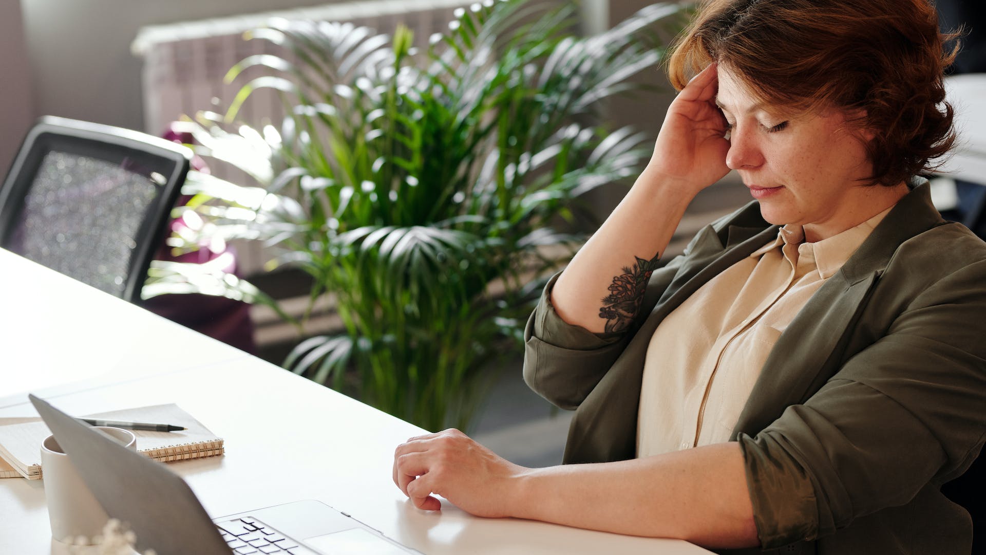 nauseous woman while working on laptop