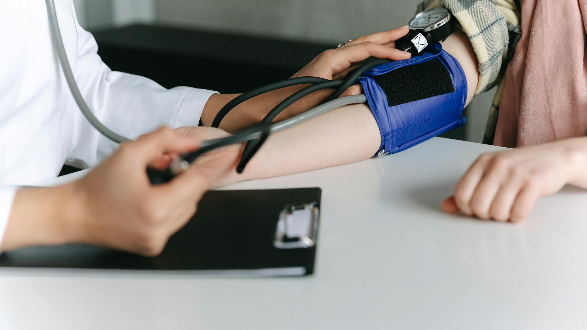 doctor checking patient's blood pressure